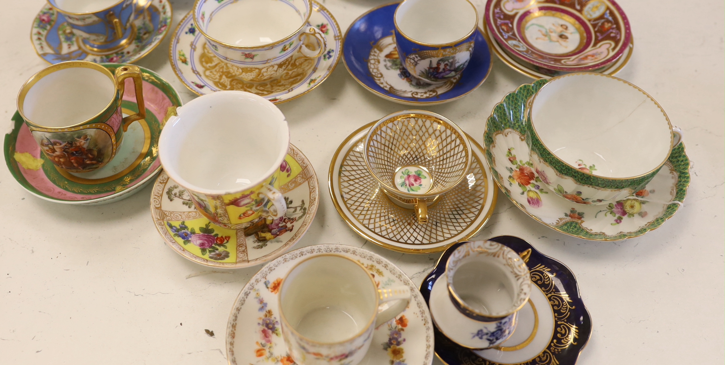 A collection of European cabinet cups and saucers, including a gilded Berlin cup and saucer (12)